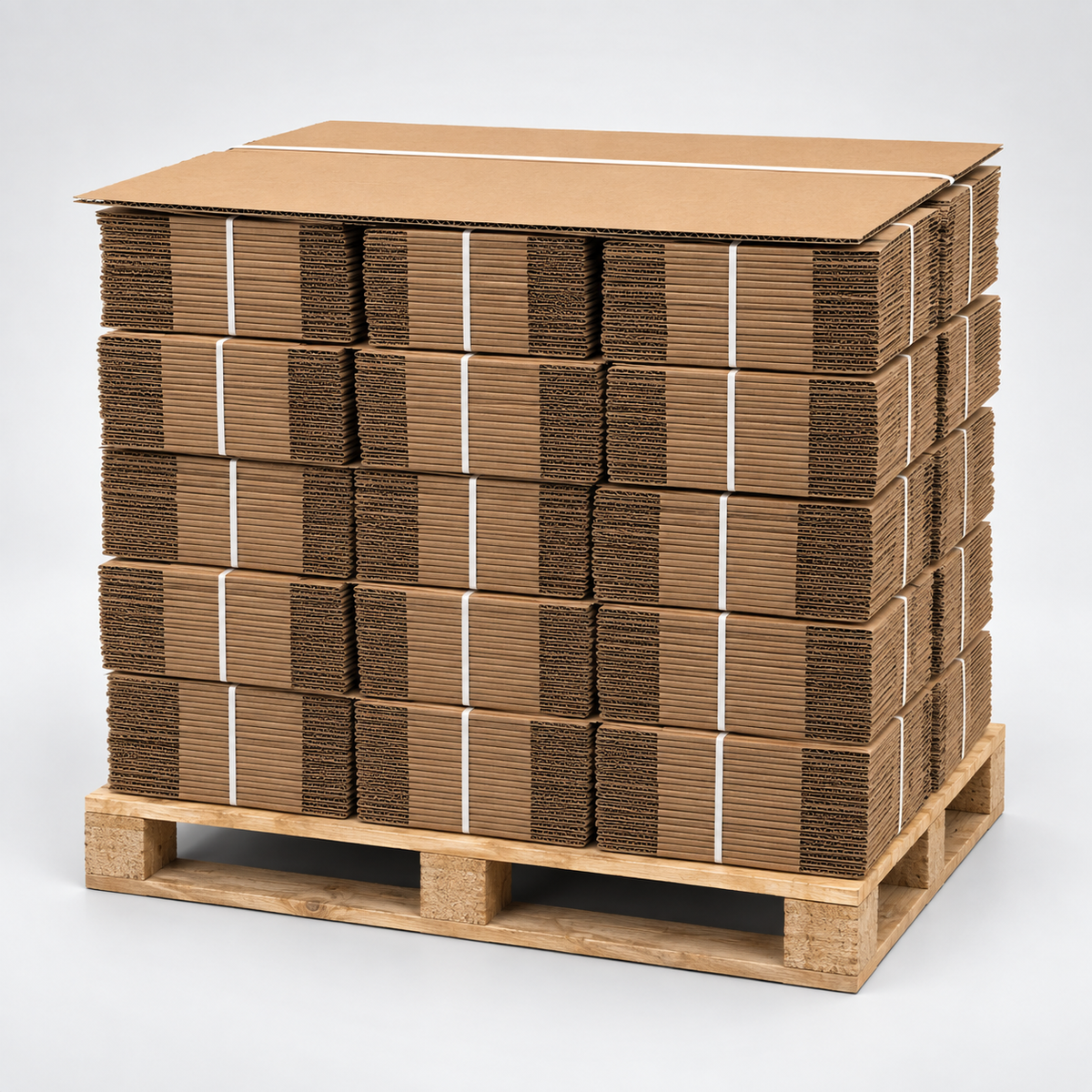 A stack of brown corrugated cardboard boxes secured with white straps on a wooden pallet, photographed against a light gray studio background.